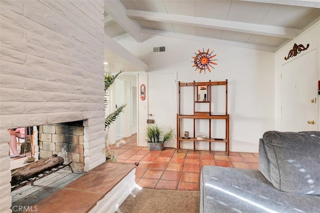 tiled living room with lofted ceiling with beams and a fireplace