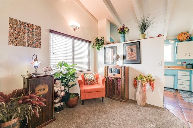 sitting room with carpet flooring, beamed ceiling, and high vaulted ceiling