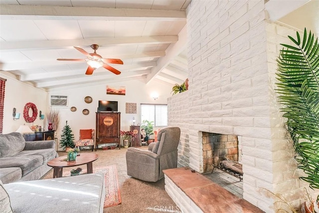 living room featuring lofted ceiling with beams, a large fireplace, ceiling fan, and carpet floors