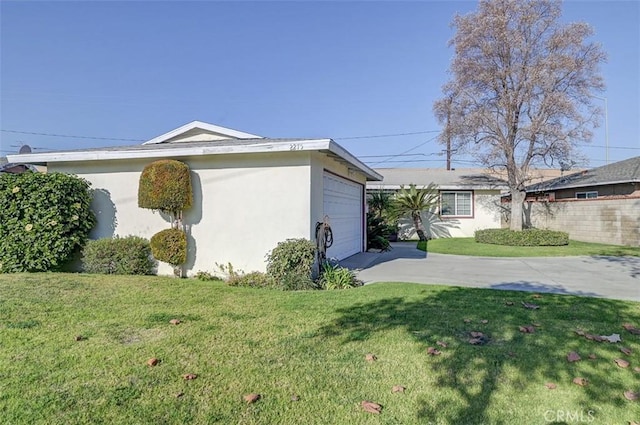 view of home's exterior with a lawn and a garage