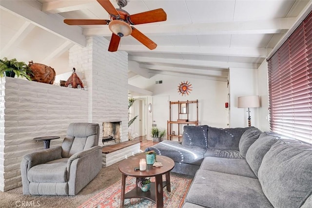 living room with carpet, a stone fireplace, vaulted ceiling with beams, ceiling fan, and a healthy amount of sunlight