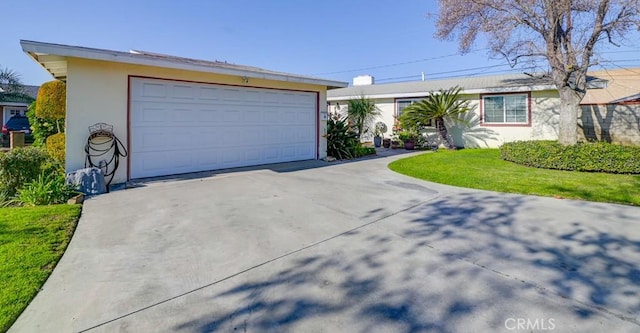 single story home with a garage and a front yard