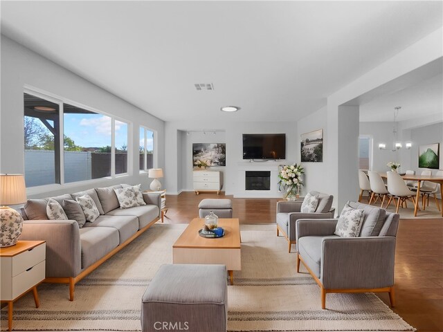 living room featuring light hardwood / wood-style floors and a notable chandelier