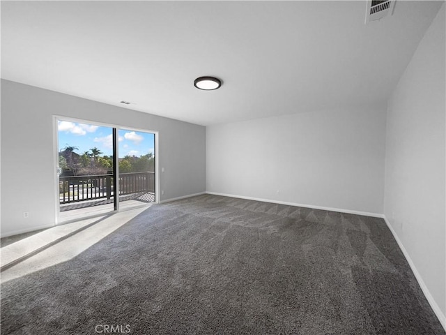 unfurnished room with baseboards, carpet floors, and visible vents