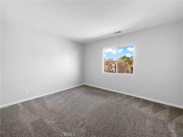 spare room with baseboards, visible vents, and carpet floors