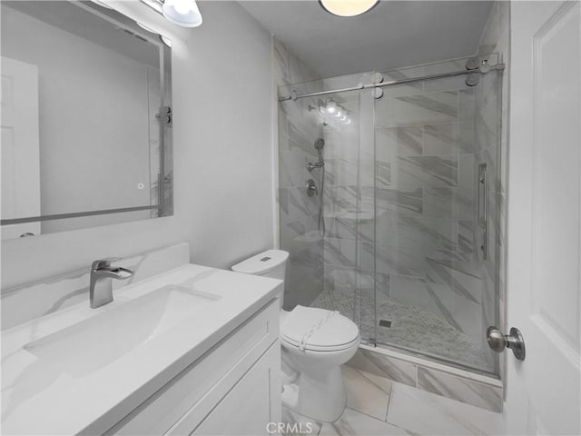 full bath featuring a stall shower, toilet, and vanity