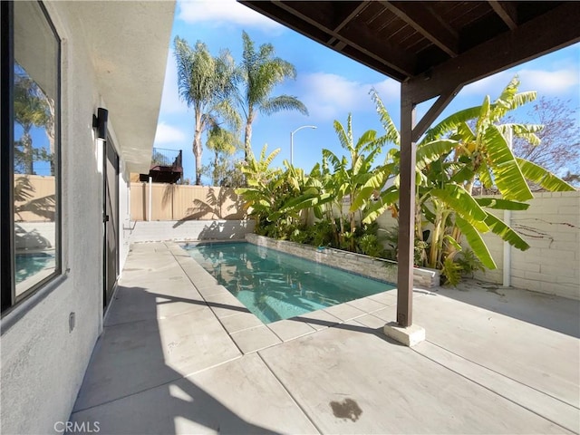 view of swimming pool with a fenced in pool, a fenced backyard, and a patio area
