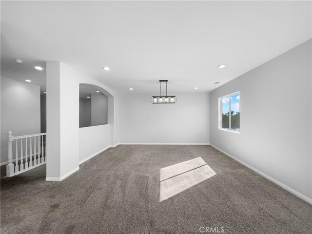 unfurnished room featuring dark carpet