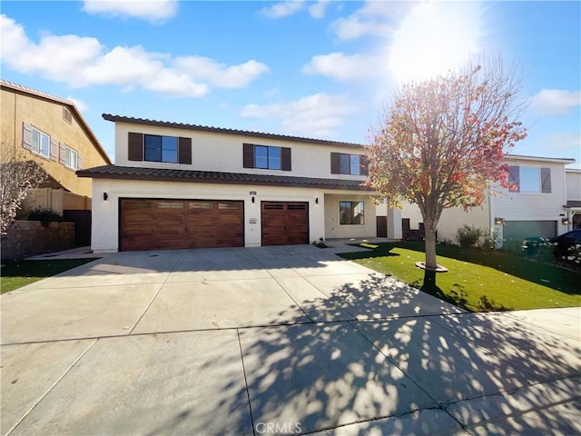 view of front facade featuring a tile roof, concrete driveway, stucco siding, a front lawn, and a garage