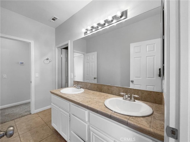 full bath with visible vents, a sink, tile patterned flooring, and double vanity