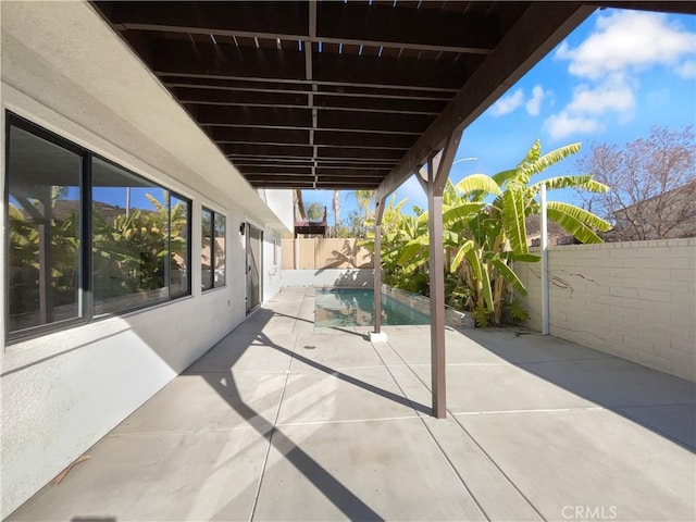 view of patio / terrace with a fenced in pool