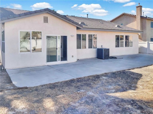back of property featuring a patio area, fence, central AC, and stucco siding