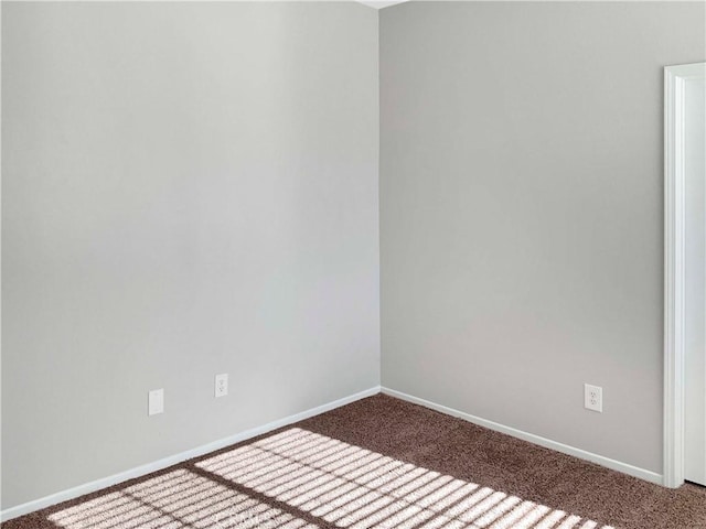 unfurnished room with carpet floors and baseboards