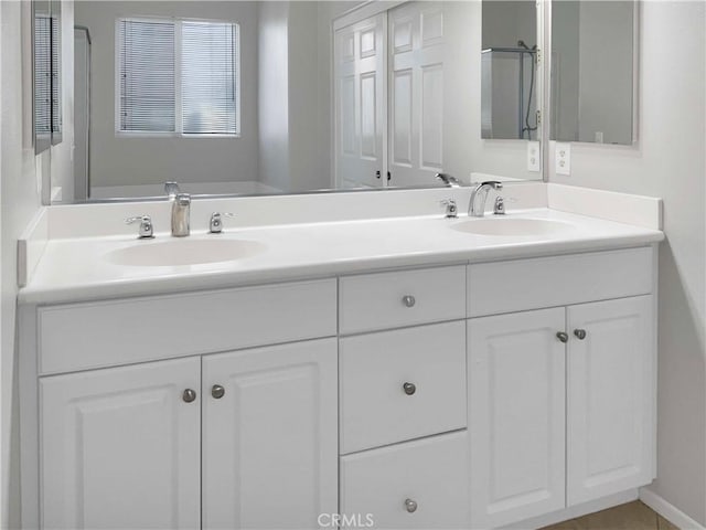 full bath featuring double vanity and a sink