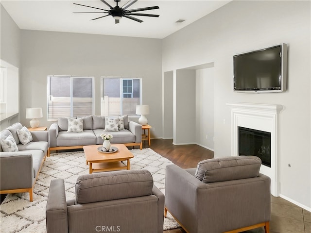 living room with dark hardwood / wood-style floors and ceiling fan