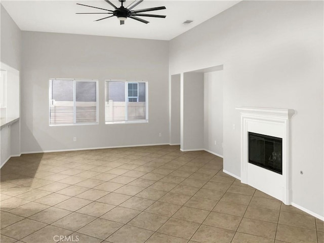 unfurnished living room featuring ceiling fan and light tile patterned flooring