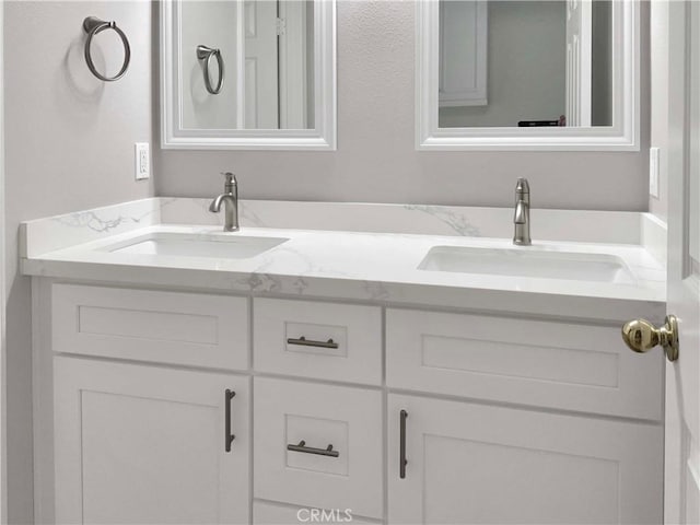 full bath with double vanity and a sink