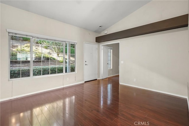 unfurnished room featuring dark hardwood / wood-style flooring and lofted ceiling