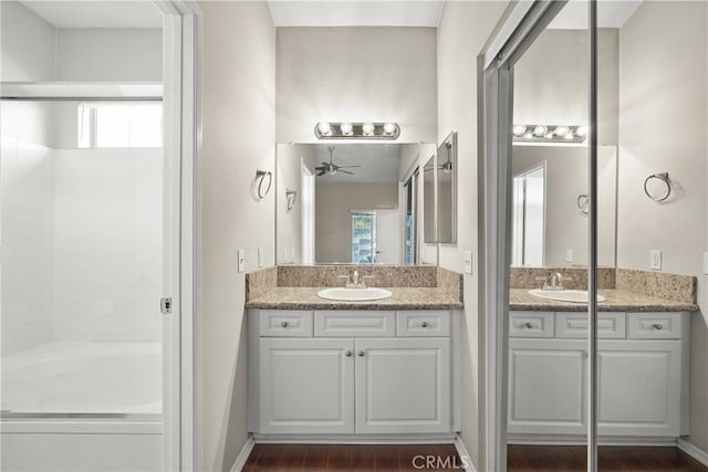 bathroom featuring a shower, wood-type flooring, vanity, and ceiling fan