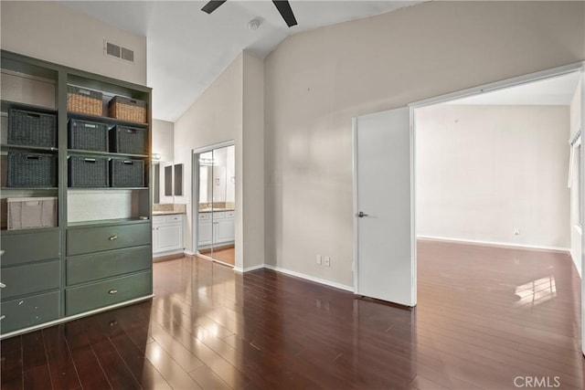 interior space featuring ceiling fan, dark hardwood / wood-style flooring, and high vaulted ceiling