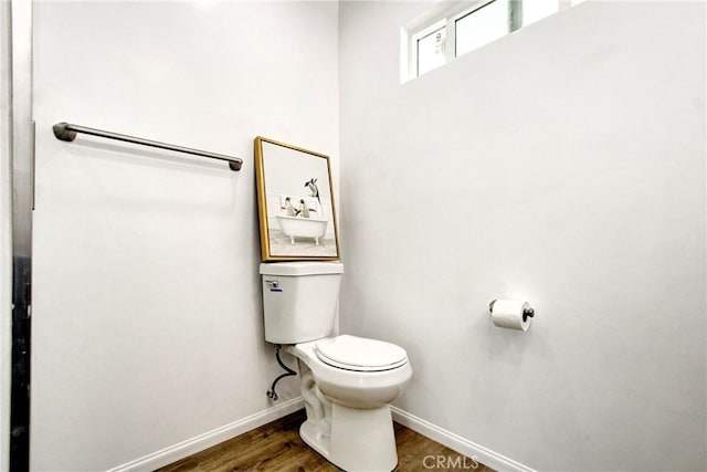 bathroom featuring hardwood / wood-style floors and toilet