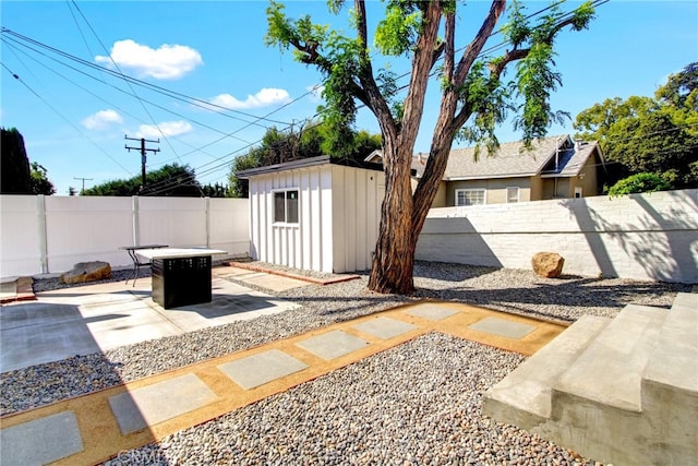 view of patio featuring a fire pit and a storage shed