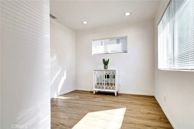 unfurnished room with a wealth of natural light and light wood-type flooring