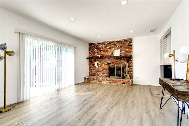 living room featuring a fireplace and light hardwood / wood-style floors