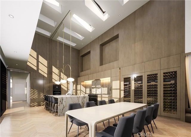 interior space featuring a towering ceiling and light parquet flooring