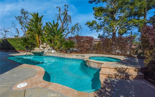 view of pool with fence, a fenced in pool, and an in ground hot tub