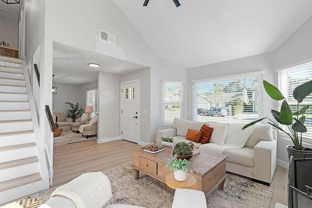 living room with high vaulted ceiling, light hardwood / wood-style flooring, and ceiling fan