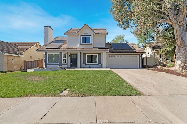 view of front facade with solar panels, a garage, and a front yard