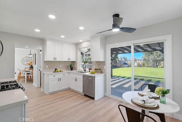 kitchen featuring stove, ceiling fan, dishwasher, light hardwood / wood-style floors, and white cabinetry