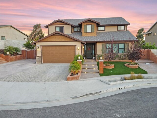 view of front of home with a garage and a yard