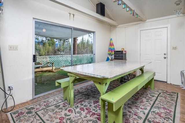 dining room featuring lofted ceiling and hardwood / wood-style flooring