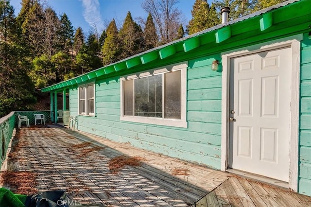 view of side of home featuring a wooden deck