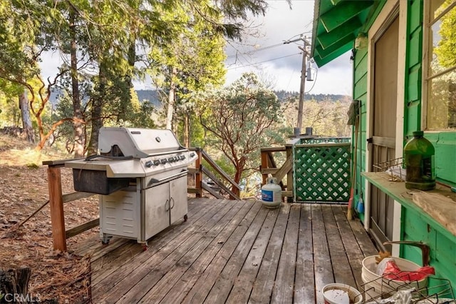 wooden deck with a grill