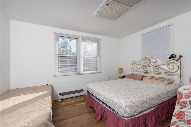 bedroom featuring wood-type flooring and baseboard heating