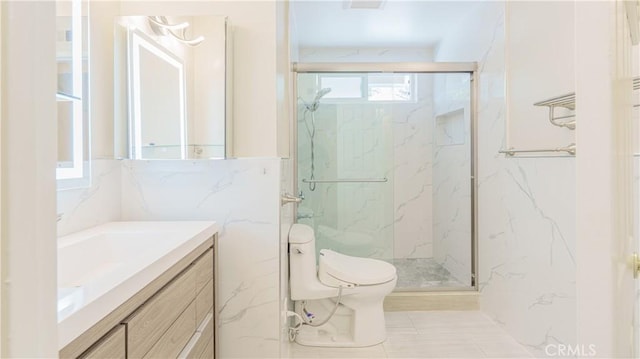 bathroom featuring vanity, a shower with shower door, and toilet