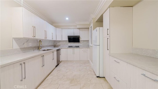 kitchen with white cabinets, white refrigerator, crown molding, sink, and gas stovetop