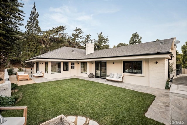 back of house featuring area for grilling, a patio area, and a yard