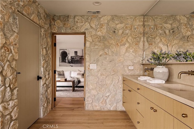 bathroom featuring hardwood / wood-style floors and vanity