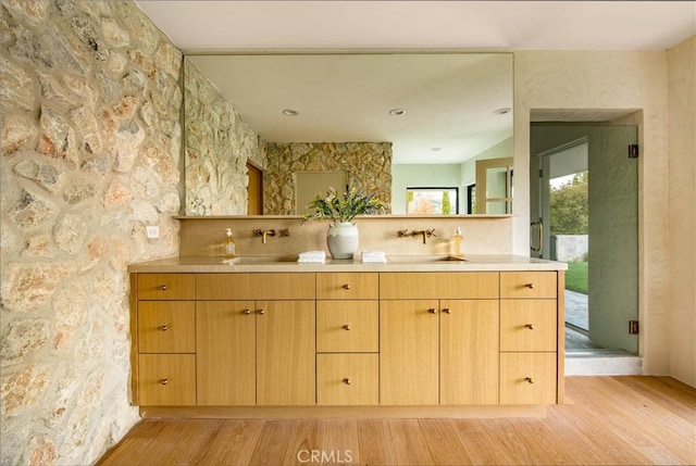 bathroom featuring hardwood / wood-style flooring, vanity, and an enclosed shower