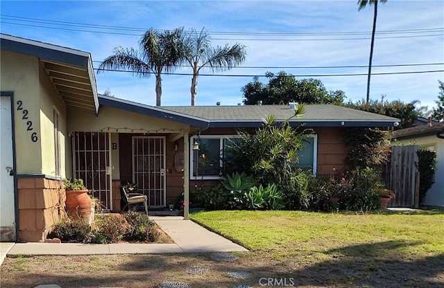 view of front of property with stucco siding and a front yard