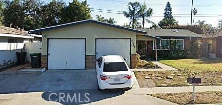 view of front facade featuring a garage and an outbuilding