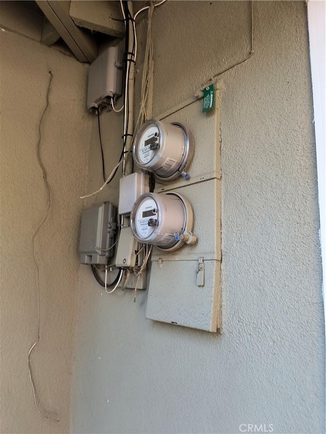 exterior details with electric meter and stucco siding