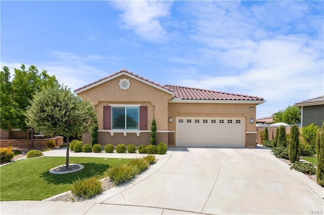 mediterranean / spanish home featuring a garage and a front lawn