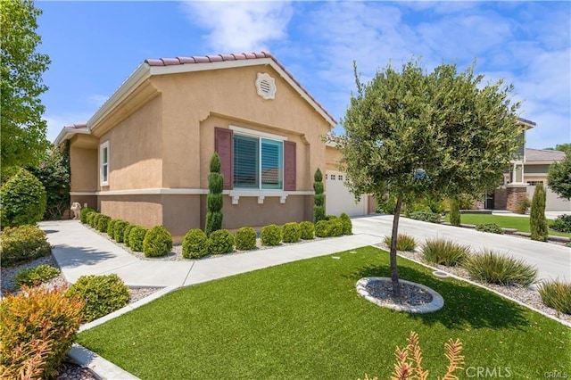 view of side of home featuring a garage and a lawn