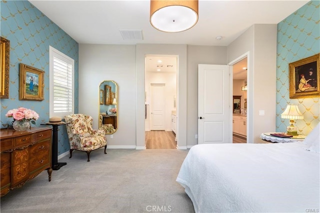 carpeted bedroom featuring connected bathroom