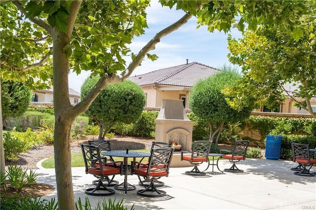 view of patio / terrace featuring exterior fireplace